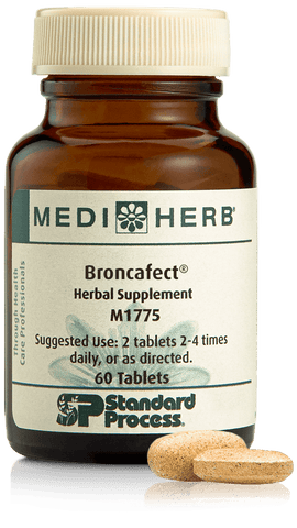 - A bottle of Broncafect herbal supplement next to a tablet.